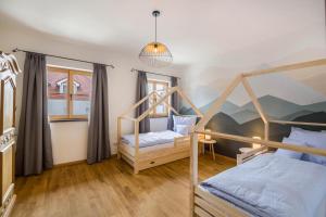 a bedroom with two bunk beds and a painting on the wall at Ferienwohnung Maria in Gilching