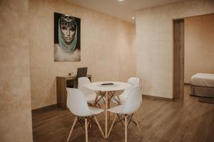バルデペニャスにあるHospedium Aloque BOUTIQUE PLAZAのテーブル、椅子、ベッドが備わる客室です。