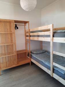 two bunk beds in a room with a lamp at Casa d'Avo - Cascais-Estoril in São Domingos de Rana