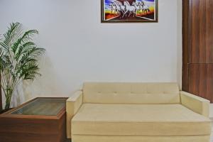 a living room with a couch and a coffee table at Treebo Trend Krishna Regency ISBT Bus Stop in Bhopal