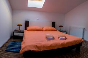 a bedroom with a large bed with two towels on it at Guest House Buk Rastoke in Slunj