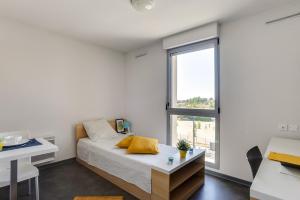 Ένα ή περισσότερα κρεβάτια σε δωμάτιο στο Apparteo Toulouse