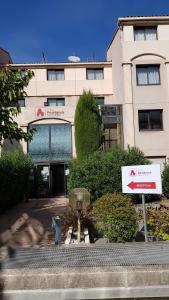 a building with a sign in front of it at City Résidence Aix-en-Provence in Aix-en-Provence