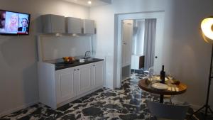 a kitchen with a sink and a table at Paderagi in Santa Domenica
