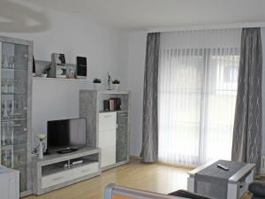 a living room with a flat screen tv and a living room at Ferienhaus Nr 50, Kategorie Premium, Feriendorf Hochbergle, Allgäu in Karlsebene
