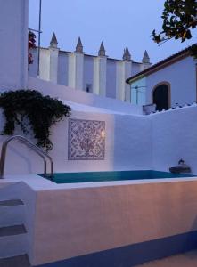 a swimming pool in front of a building at Casa do Páteo in Vila Nova da Baronia