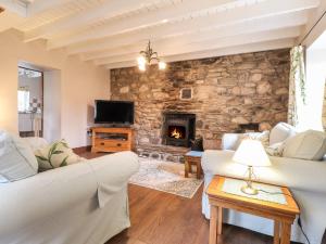 a living room with couches and a stone fireplace at Step in in Fishguard