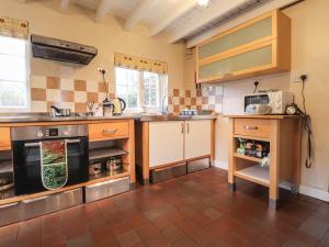 a kitchen with a sink and a stove at Step in in Fishguard