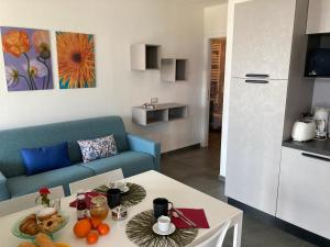 a living room with a couch and a table with food on it at Residence Il Bosso in Domaso