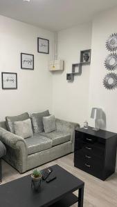 a living room with a couch and a table at BvApartments Queensgate 1 in Huddersfield