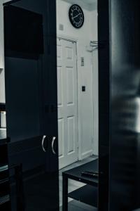 a room with a door and a clock on the wall at BvApartments Queensgate 1 in Huddersfield