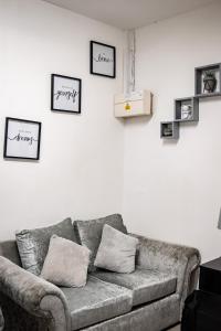 a living room with a couch and pictures on the wall at BvApartments Queensgate 1 in Huddersfield