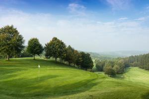 a view of a golf course with a green field at Gutshof Penning in Rotthalmünster