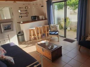 a living room with a couch and a table at The Little Cottages in Howick