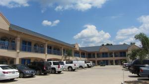 a parking lot in front of a large building at Regency Inn Porter in Porter