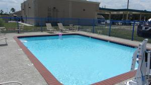 a large swimming pool with chairs and a fence at Regency Inn Porter in Porter