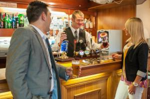 a man and a woman standing at a bar at Templestowe Hotel, Number One for Entertainment in Torquay in Torquay