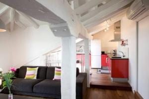 a living room with a couch and a kitchen at Pensión Iturriza in Donostia-San Sebastián