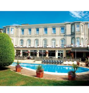 a large building with a pool in front of it at Templestowe Hotel, Number One for Entertainment in Torquay in Torquay