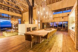 a dining room with a large wooden table and chairs at TimBila Private Villa in Omaruru