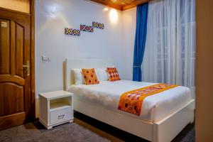 Ein Bett oder Betten in einem Zimmer der Unterkunft Villa Asimba