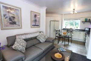 a living room with a couch and a kitchen at Northumberland-Hideaways in Kielder