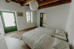 A bed or beds in a room at Casa Botár Vendégház