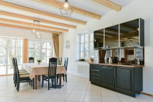 a kitchen and dining room with a table and chairs at Stay Lagom in Plateliai