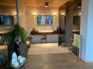 a large bathroom with a sink and a mirror at Poolvilla in Caputh