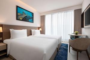 A bed or beds in a room at Radisson Hotel Danang