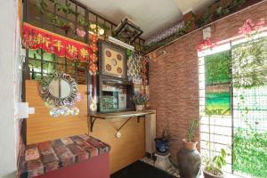 a room with a brick wall and a window at SPOT ON 90305 Hen Hen Hotel in Kulai