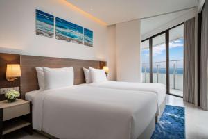 A bed or beds in a room at Radisson Hotel Danang