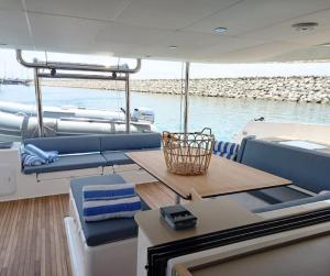 a table and chairs on a boat in the water at Marina Yacht Charter in Rosignano Solvay
