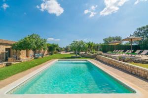 a swimming pool in the backyard of a house at Sa Punta in Son Carrió