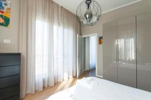 米蘭的住宿－YouHosty - Algardi 5，一间卧室配有一张床和一个吊灯