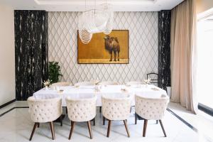 a large dining room with a table and chairs at Resident City Hotel in Almaty