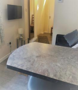 a large concrete table in a living room with a couch at Little Park Holiday Homes Self Catering Cottages 1 & 2 bedrooms available close to Tutbury Castle in Tutbury