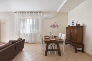 a living room with a table and a couch at Villa Irma with private pool in Noci