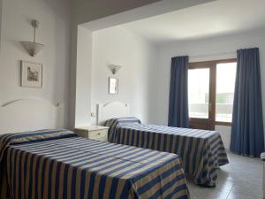 Posteľ alebo postele v izbe v ubytovaní Hostal CAN GALLU