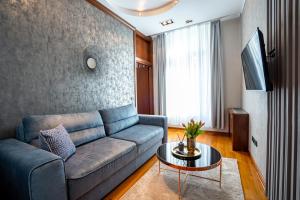 a living room with a couch and a table at NATALI Luxury suites PARKING in Belgrade