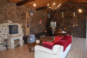 a living room with a couch and a fireplace at Fogar de Insua in Touro