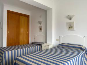 Posteľ alebo postele v izbe v ubytovaní Hostal CAN GALLU
