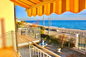 a balcony of a house with a view of the ocean at Villa Tripepi in Bova Marina