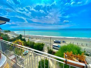 a view of a beach and the ocean from a balcony at Villa Tripepi in Bova Marina