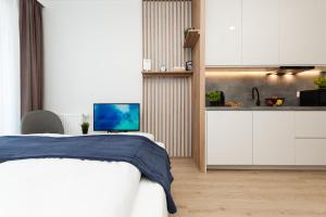 a bedroom with a bed and a kitchen at Dream Team Industria in Bydgoszcz