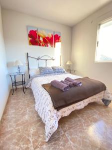 A bed or beds in a room at S&H El Caprichoso