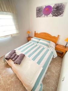 A bed or beds in a room at S&H El Caprichoso