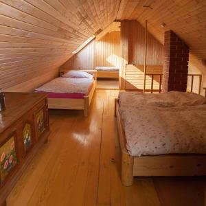a room with two beds in a wooden cabin at Vacation House Jurček in Radovljica