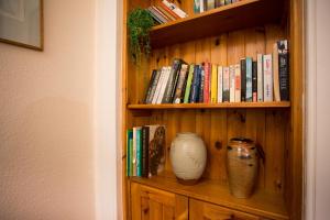 a book shelf with a vase and books on it at The Mains in Elgin