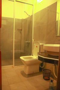 a bathroom with a toilet and a shower and a sink at OREO BEACH HOTEL KALUTARA in Kalutara